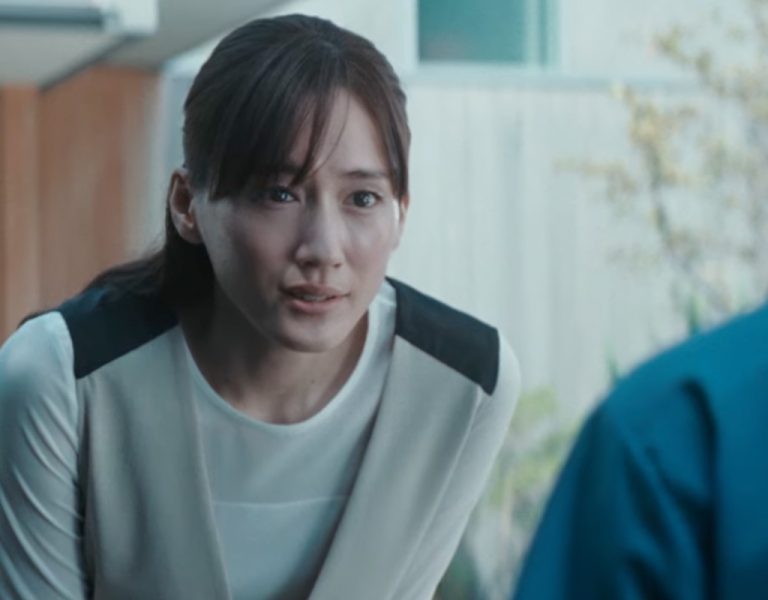 A woman leaning forward and talking to someone