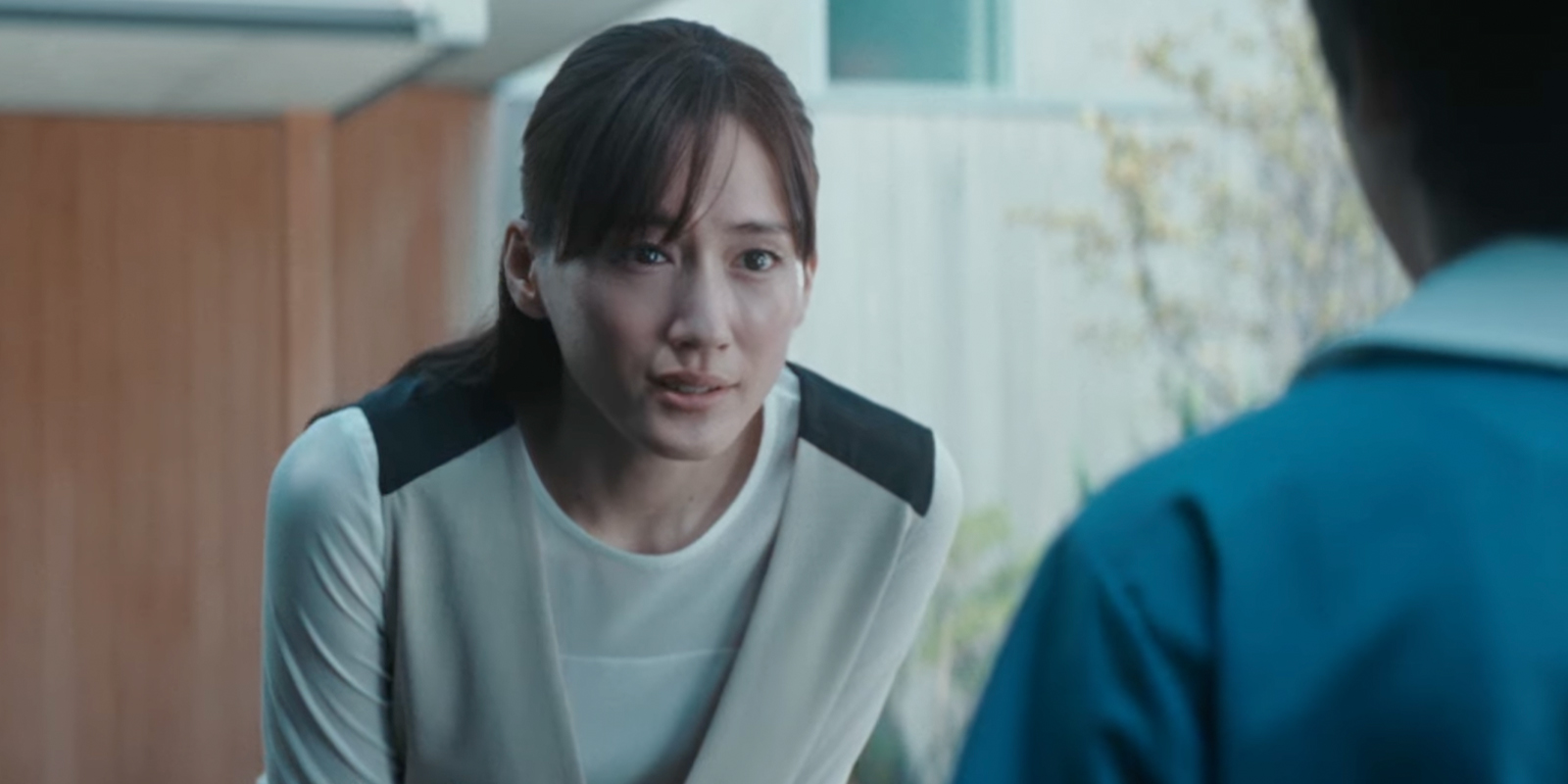 A woman leaning forward and talking to someone