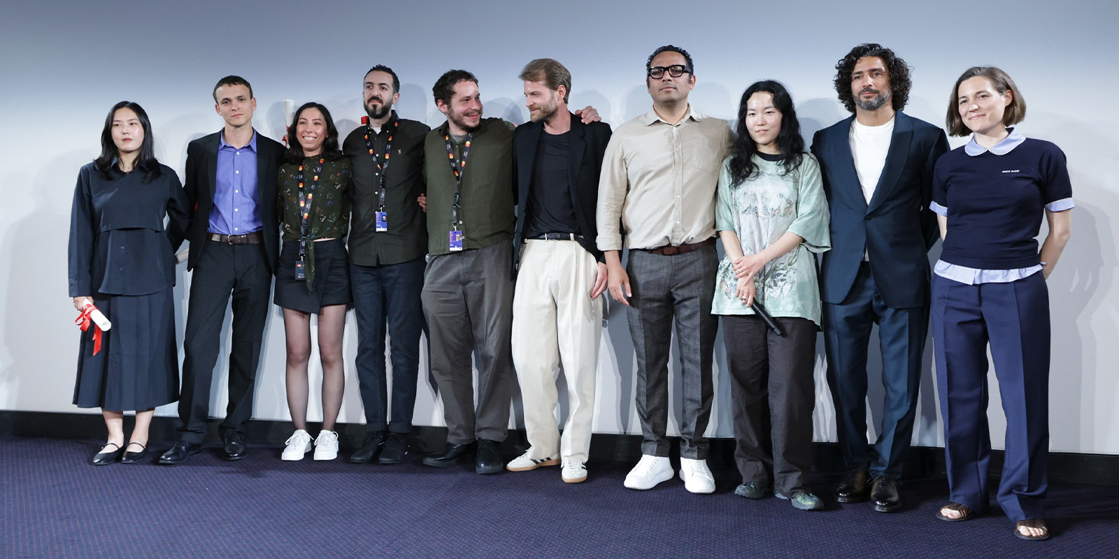 A group of people posing on stage