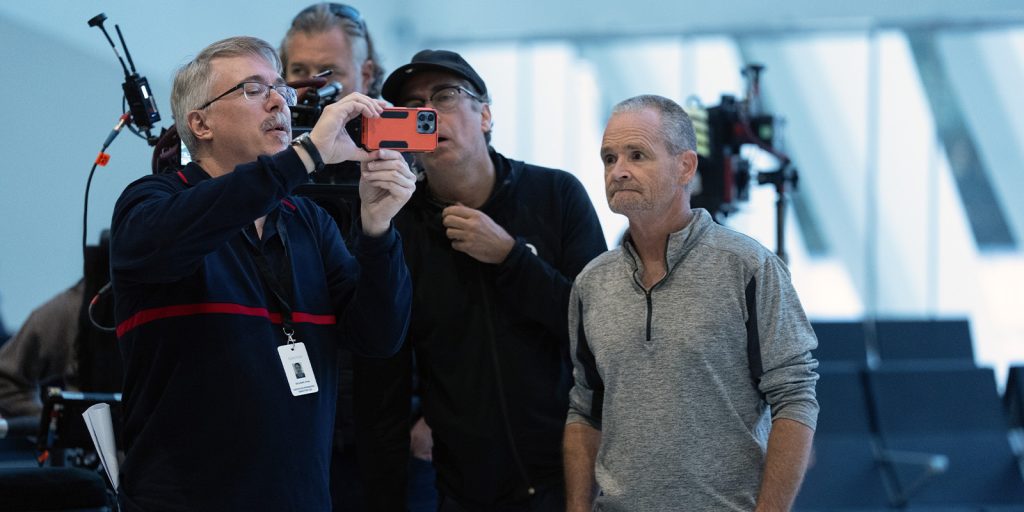 A group of people looking at a phone screen