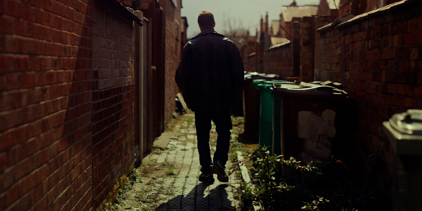A man walking down an alley
