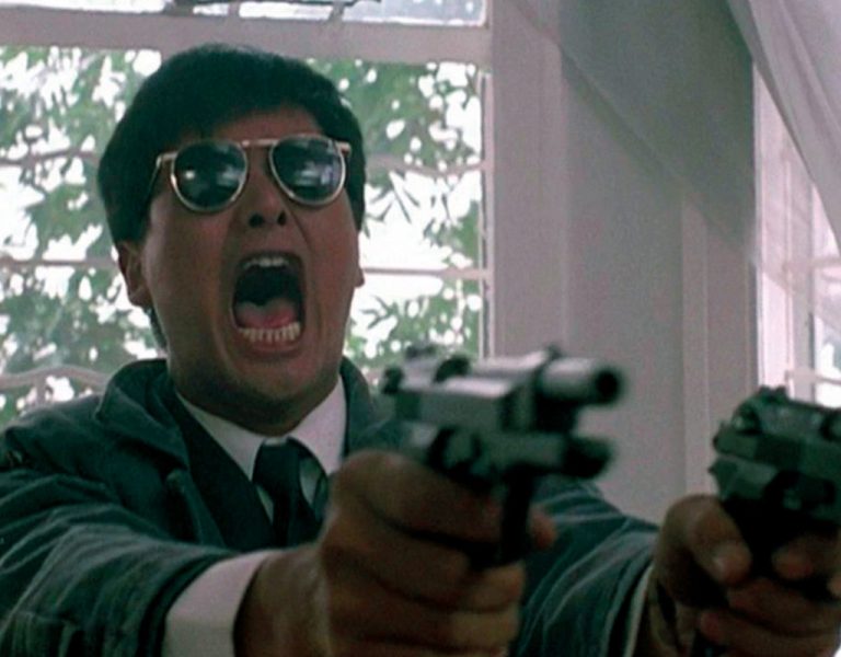 A man holding two pistols