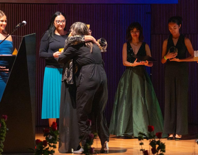 A group of people celebrating on stage