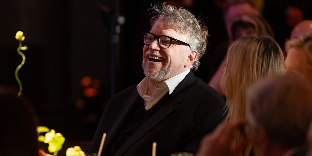 Guillermo del Toro laughing at a dinner table