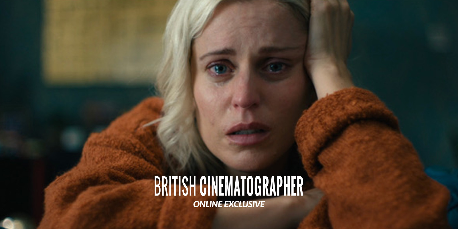 A distressed woman with short blonde hair and a tear-streaked face rests her head on her hand, wearing a rust-coloured jumper. The words British Cinematographer Online Exclusive are overlaid on the image.