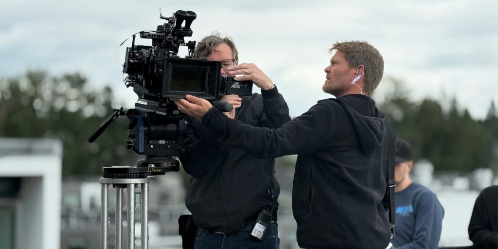 Two people operating a camera
