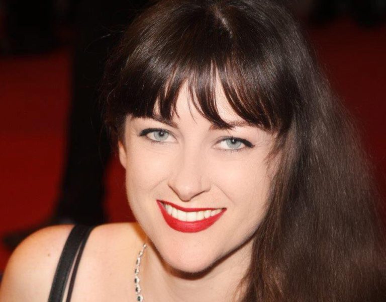 A woman smiling into camera