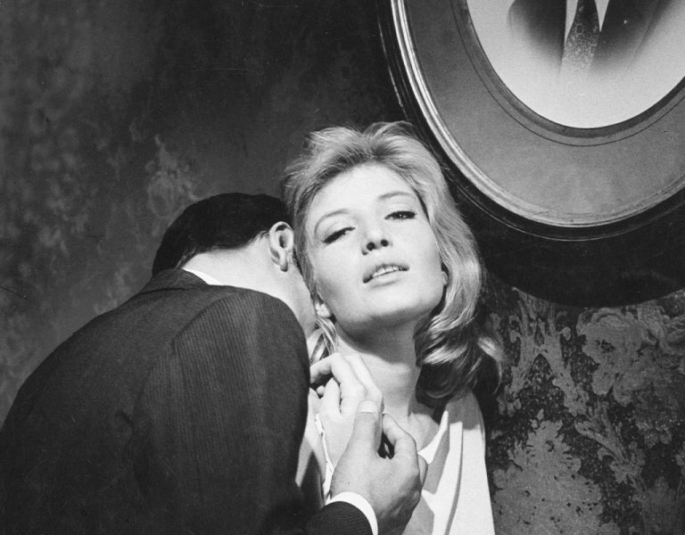 A man kissing a woman's neck