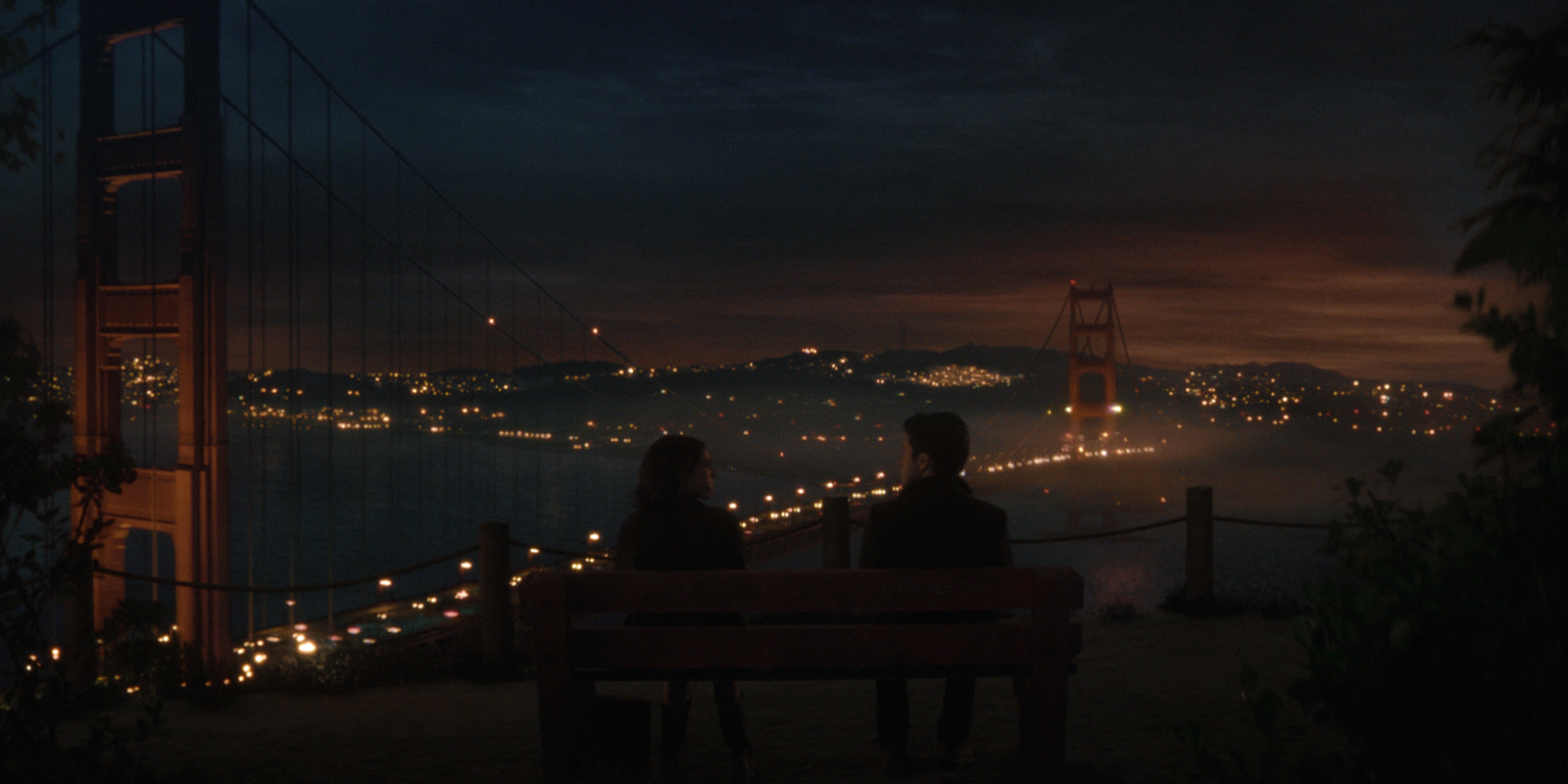 Two people overlooking the Golden Gate Bridge 