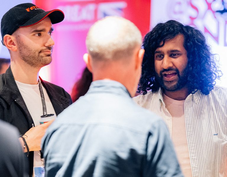 A group of people talking at a networking event