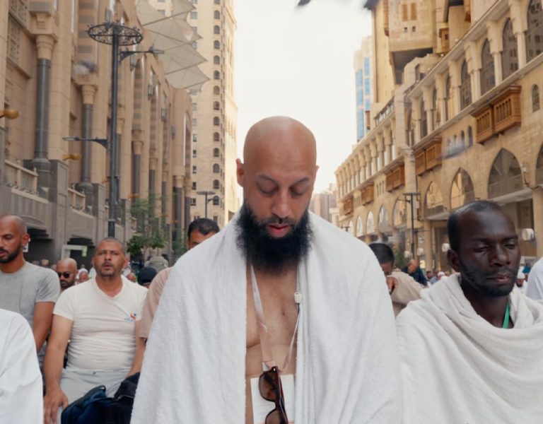People gathered in robes praying together