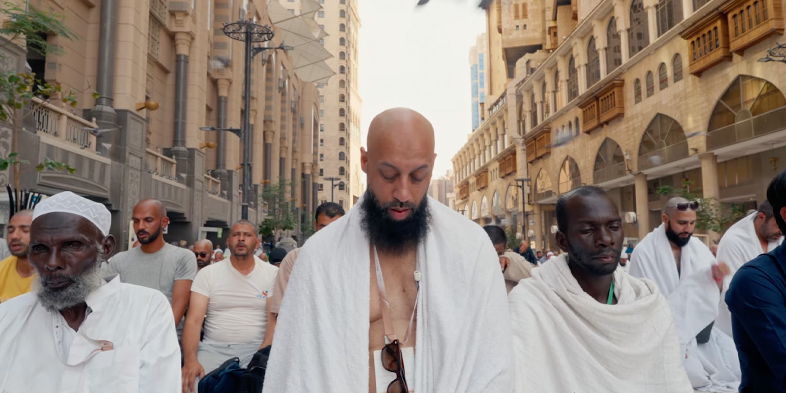 People gathered in robes praying together