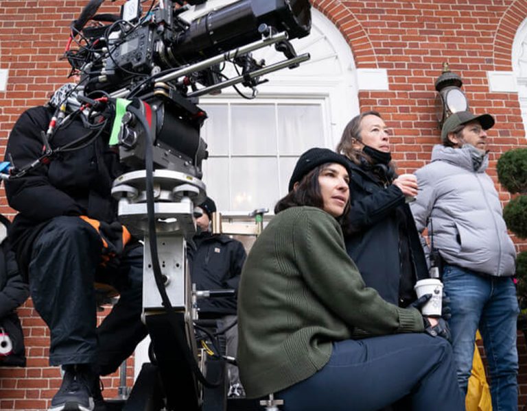 Film crew on set outside a building