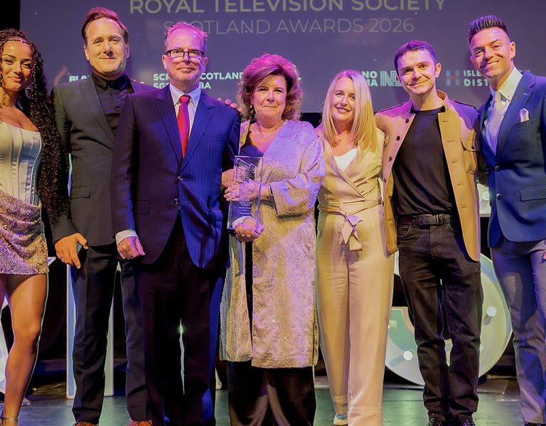 A group of people celebrating on stage