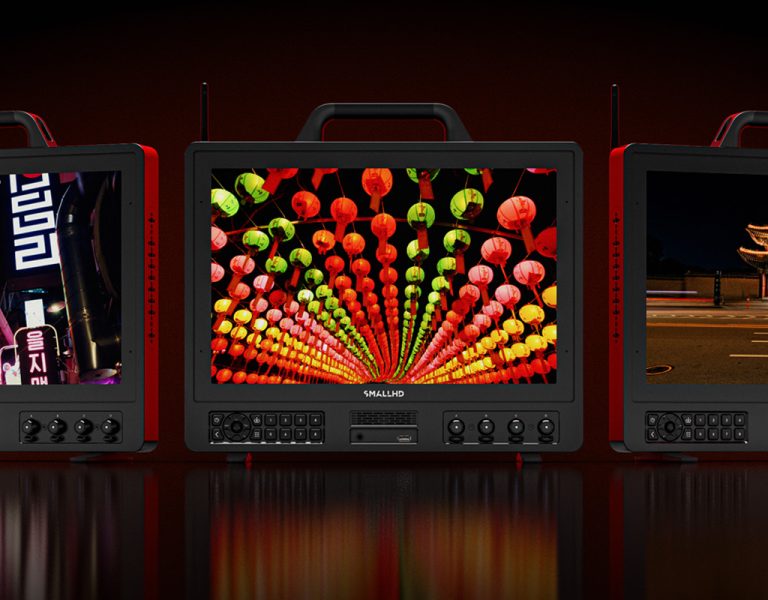 Three monitors on a colourful background