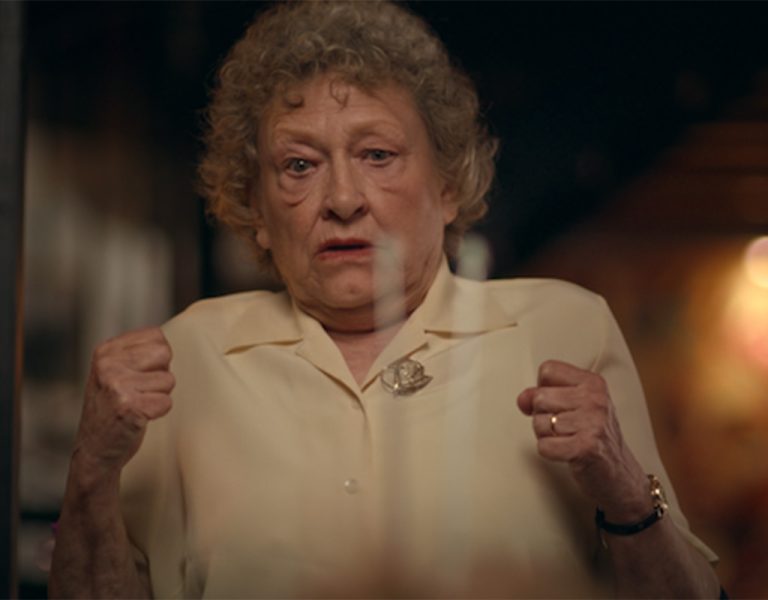 An elderly woman looking shocked