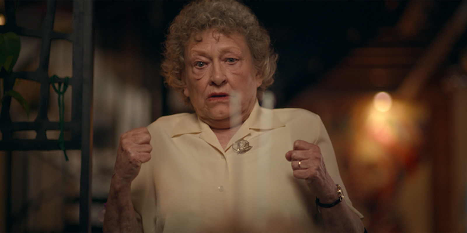 An elderly woman looking shocked