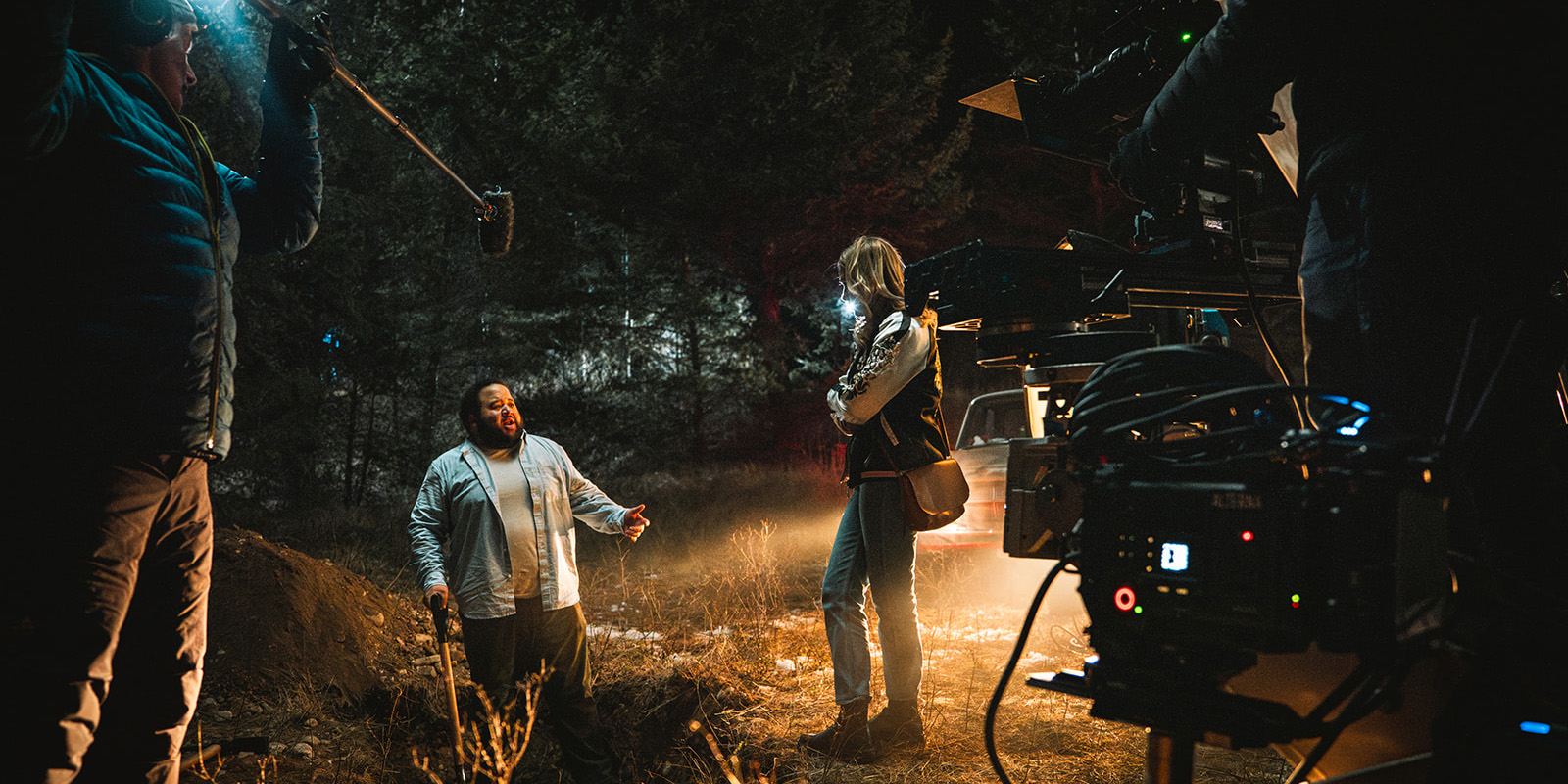 Film crew filming cast at night