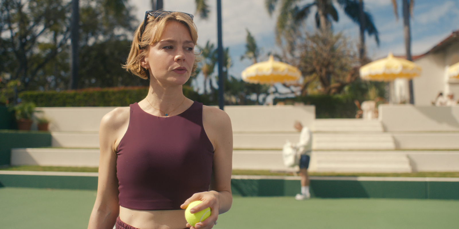 Two people playing tennis in the sun