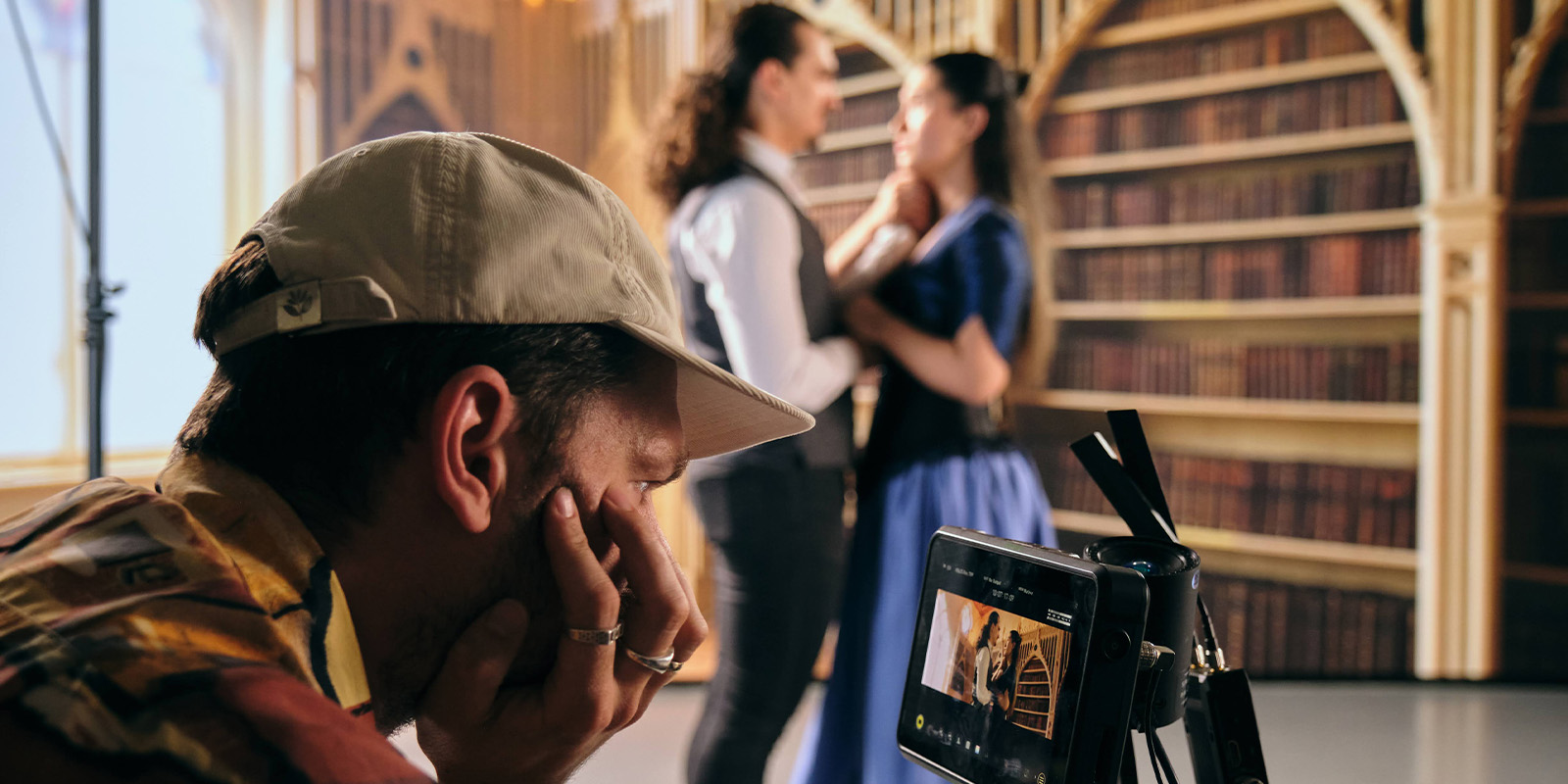 A person filming two people on a VP stage