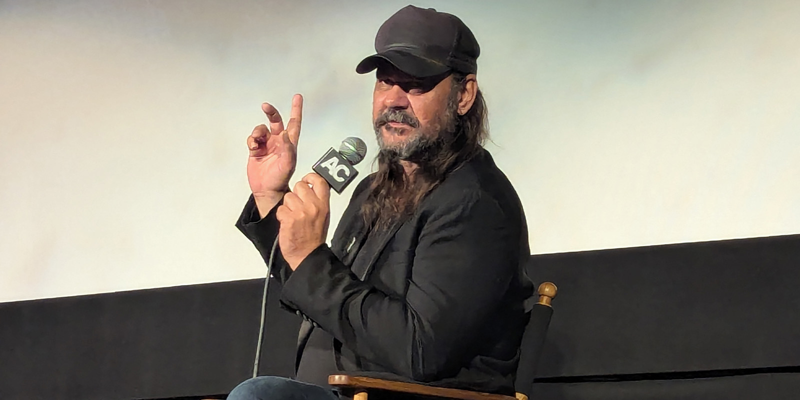 A man speaking with a microphone 