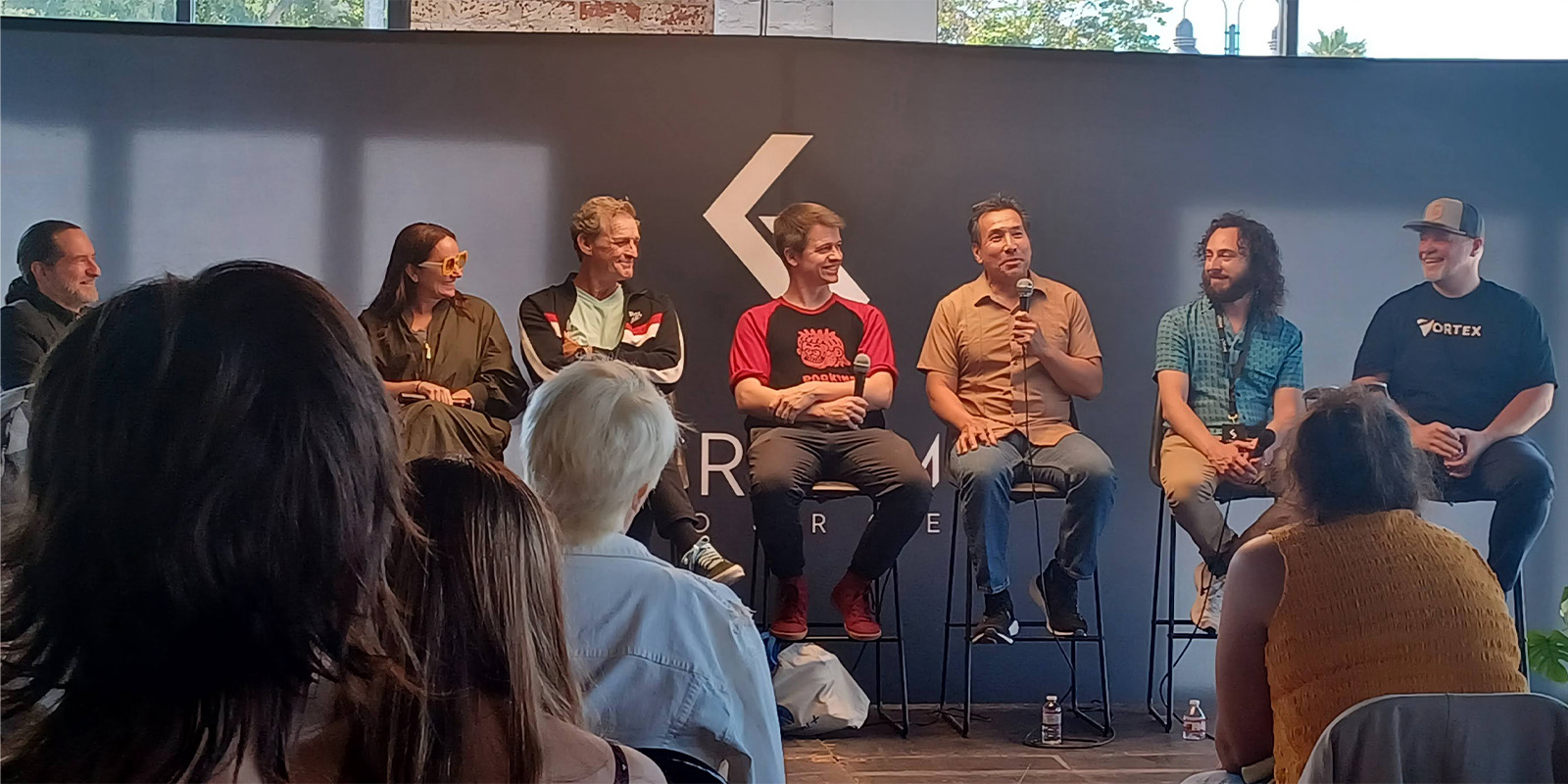 People gathered talking on a panel
