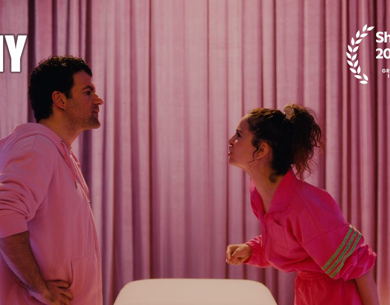 Two people arguing against a pink curtain