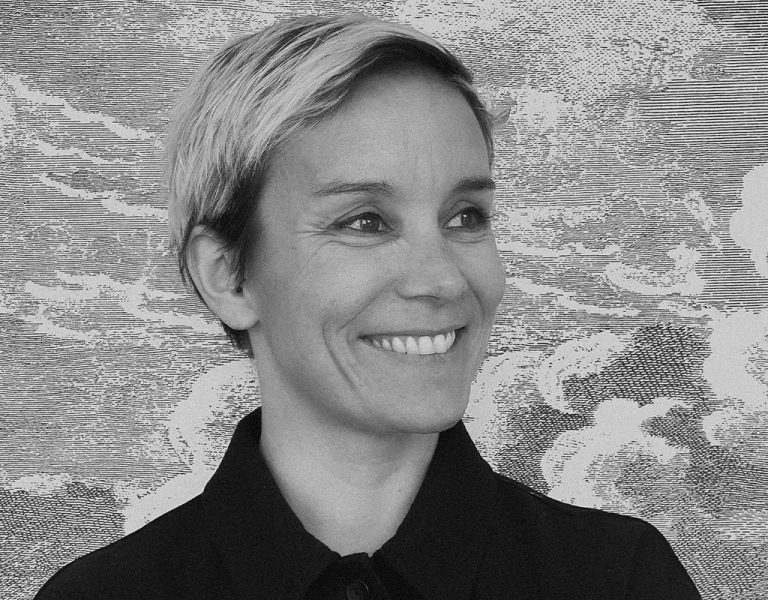 A woman smiling in a black and white photo
