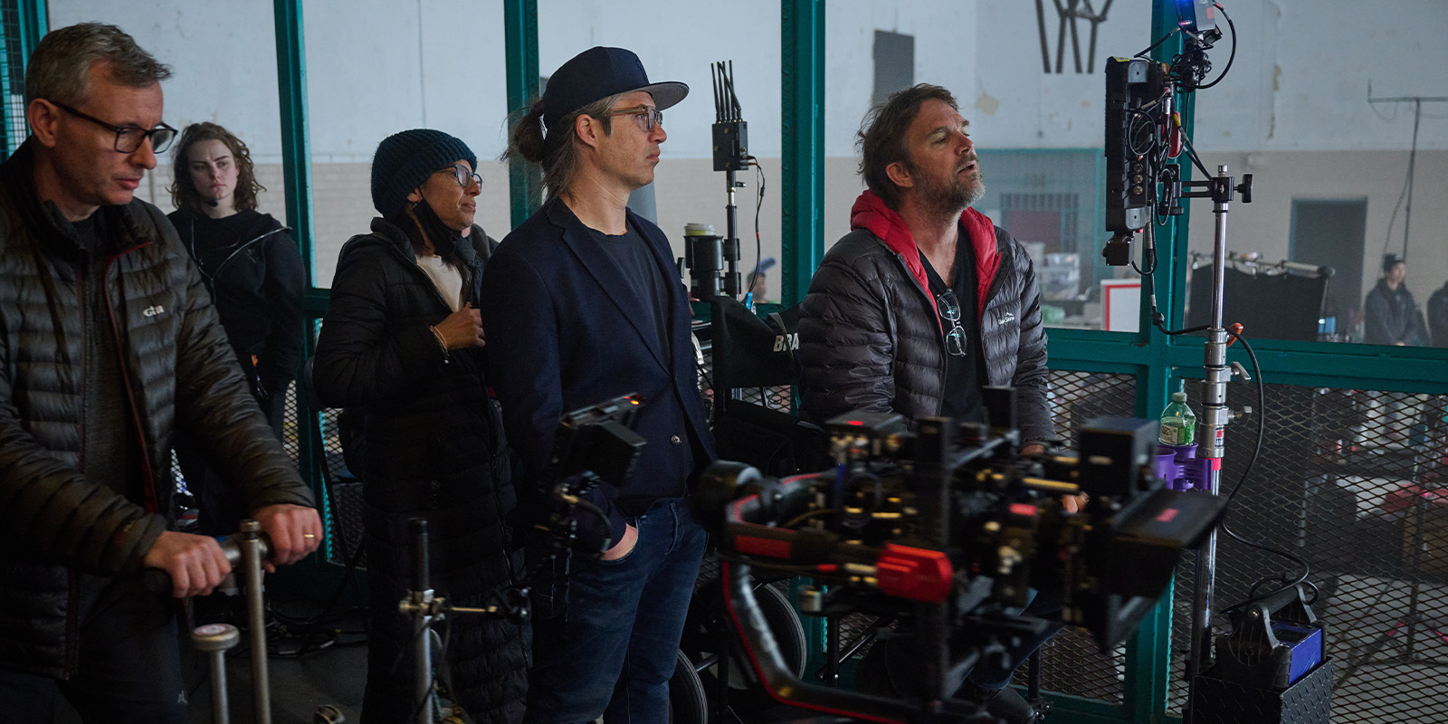 Film crew on set looking at a monitor