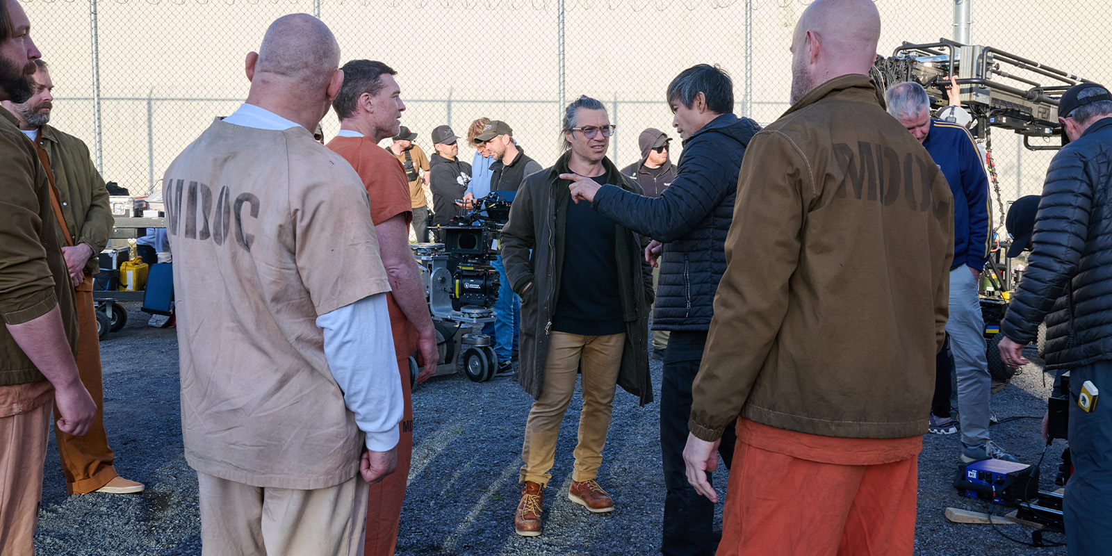 Film crew and actors on a prison set
