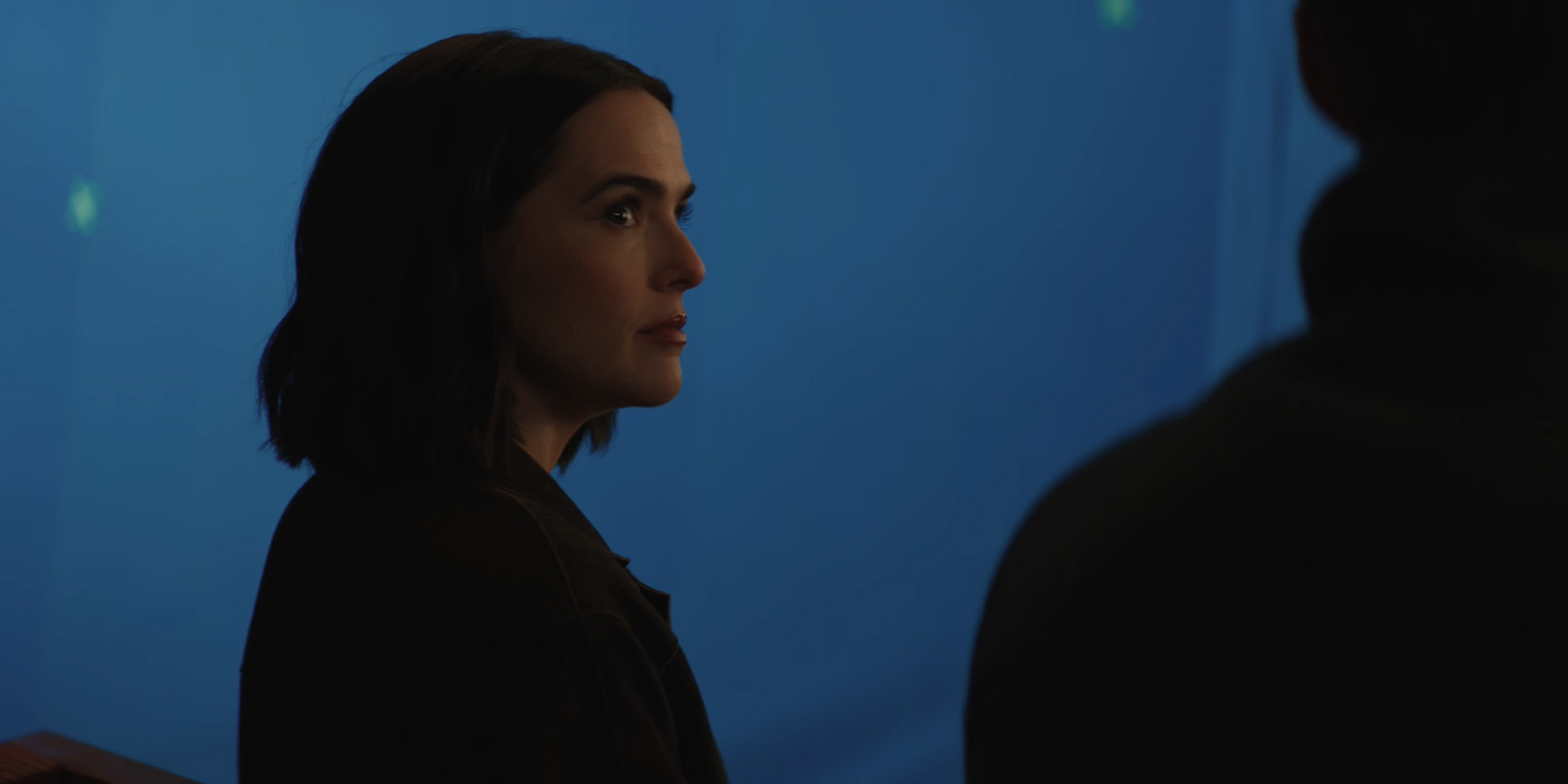 A woman looking concerned by a blue screen