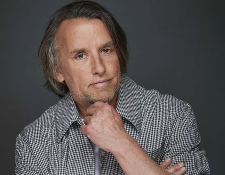 Linklater with a hand under his chin