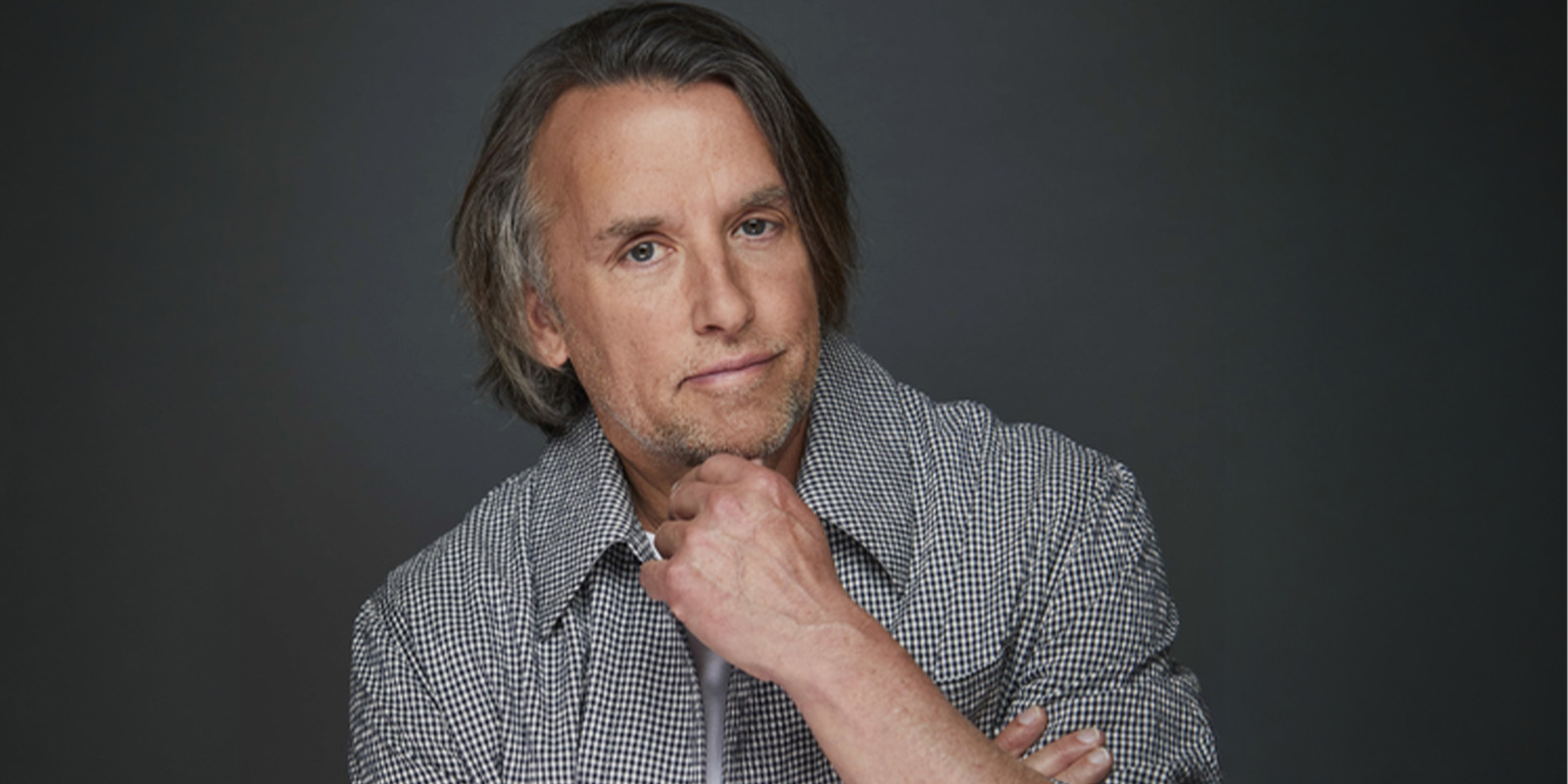 Linklater with a hand under his chin