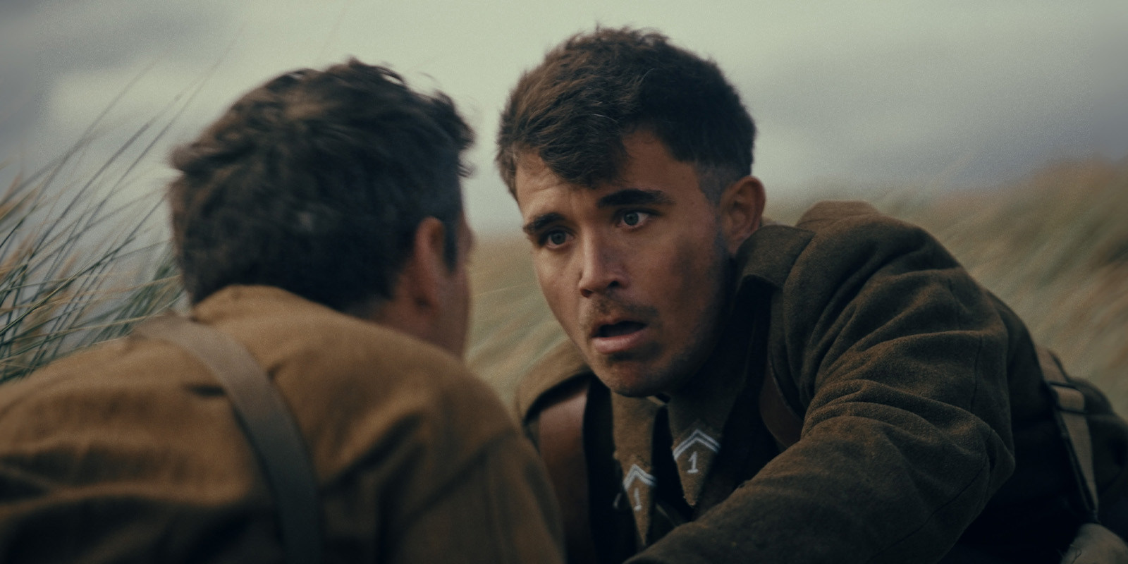 Two soldiers looking at each other on a beach