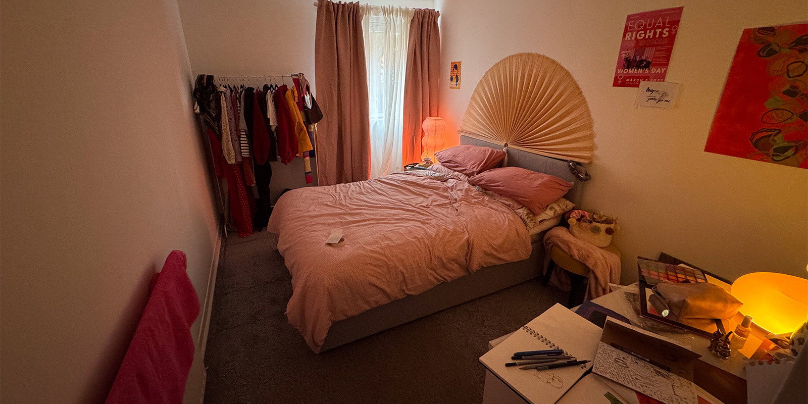 A bedroom with pink walls
