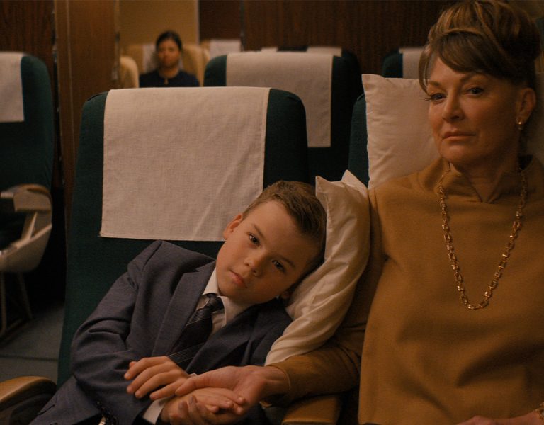 A boy and his mum sat on a plane