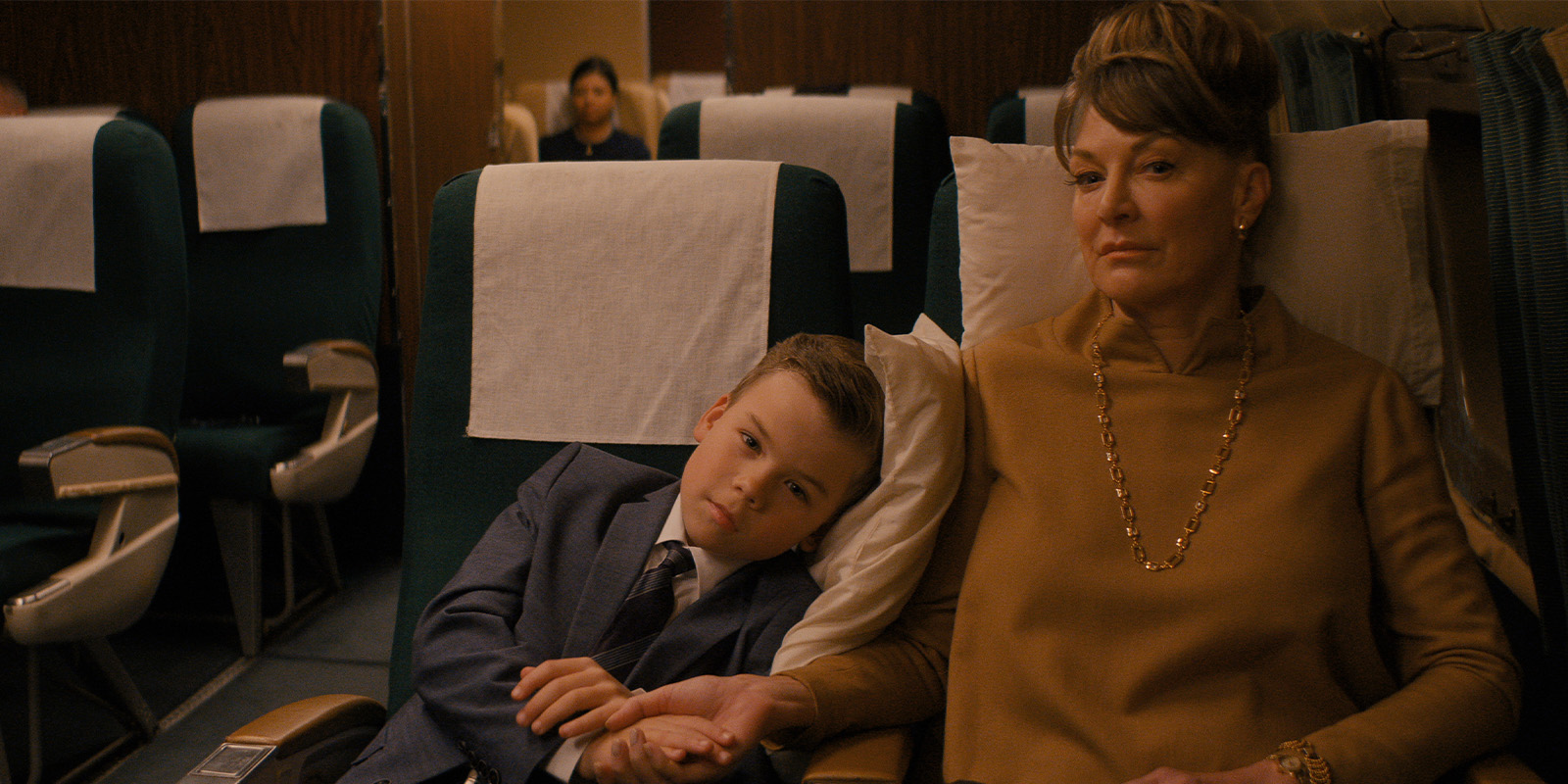A boy and his mum sat on a plane