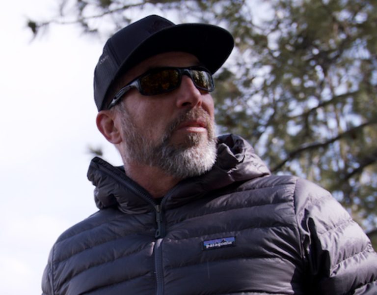 A man in a cap and a black puffa jacket