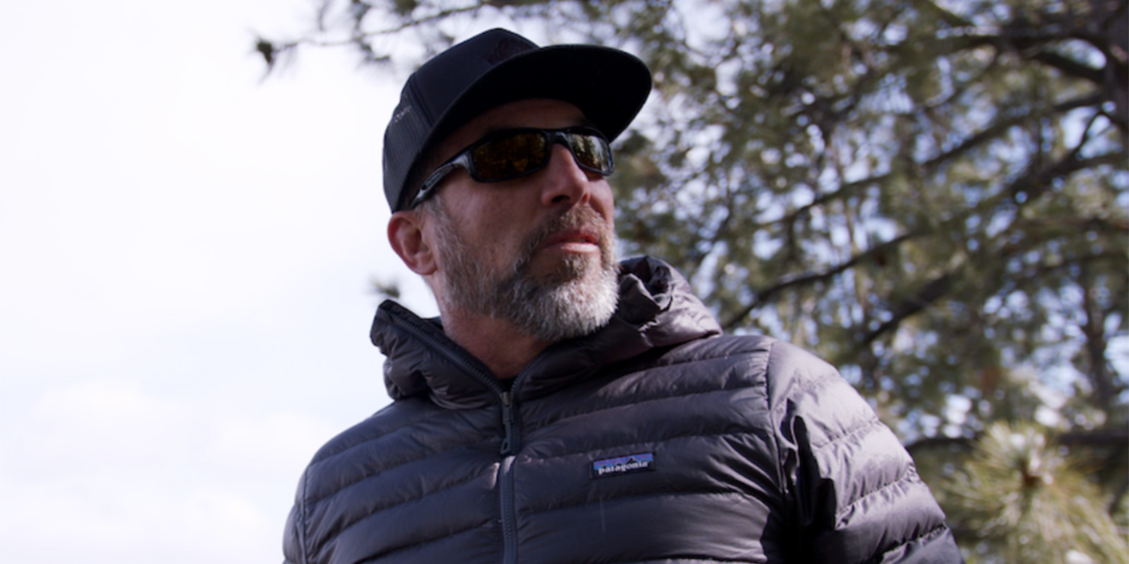 A man in a cap and a black puffa jacket
