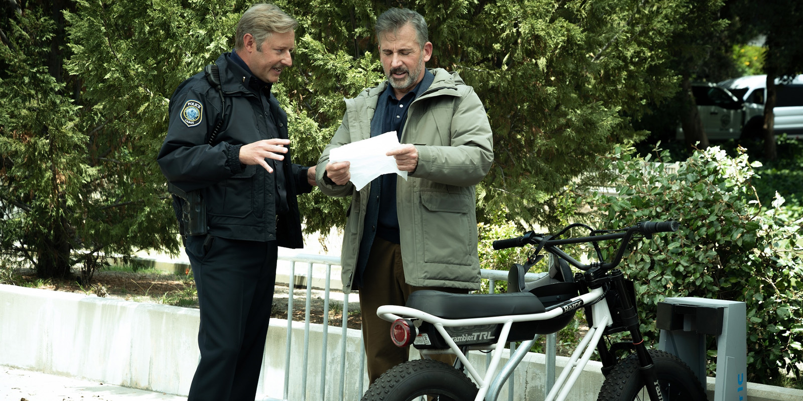 A man talking to a police officer outside