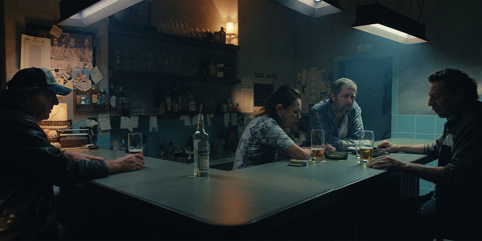 A group of people sat in a pub in the dark