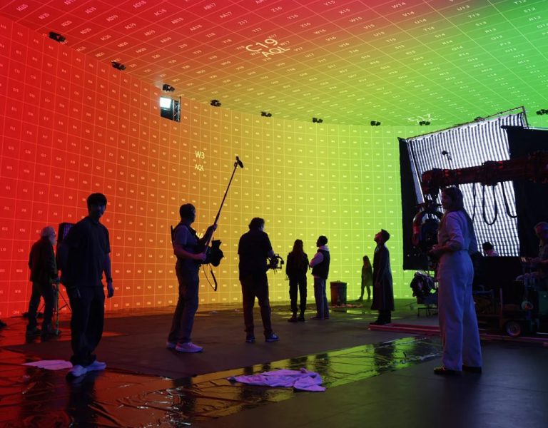 A group of people in a multicoloured room