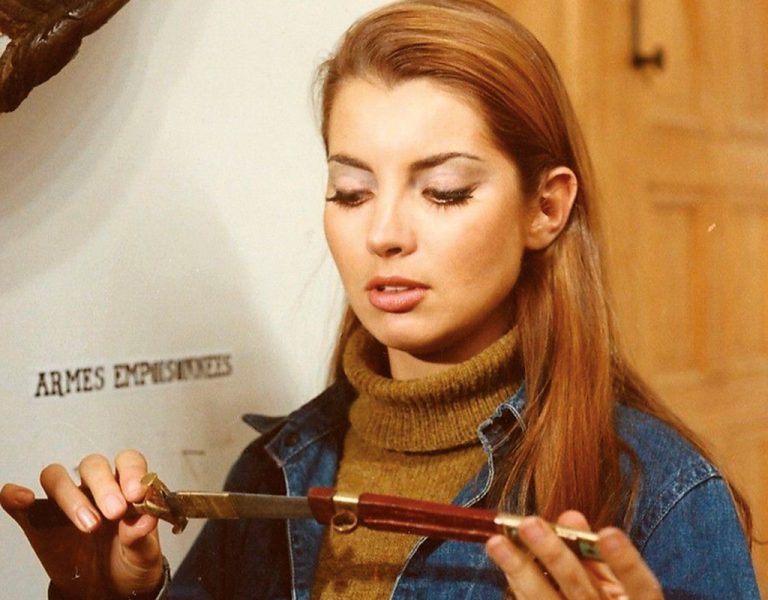 A woman looking at a knife