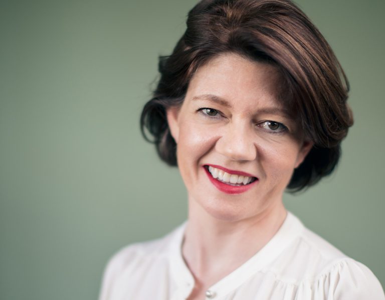 Isabel Davis smiling into camera