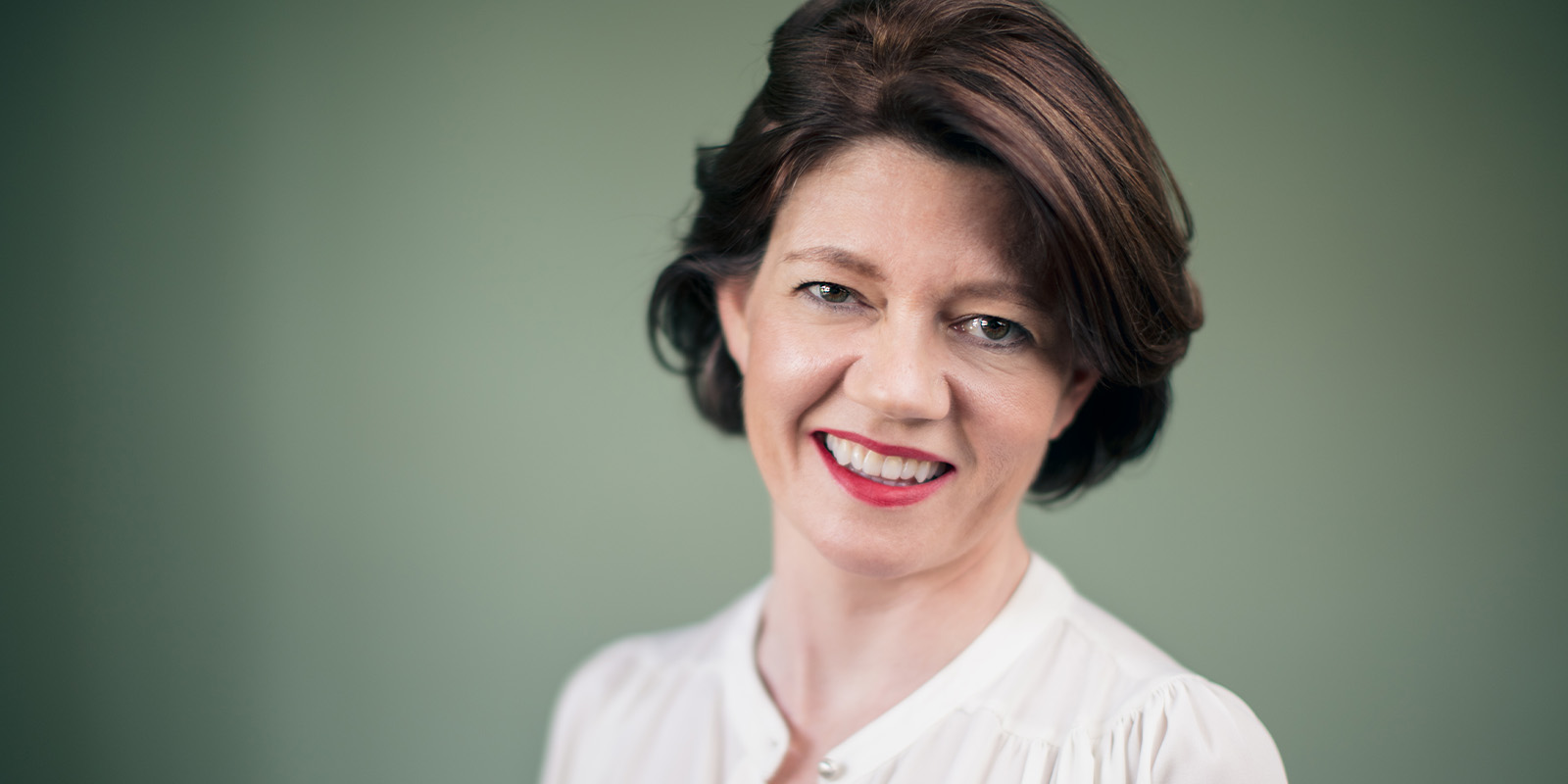 Isabel Davis smiling into camera