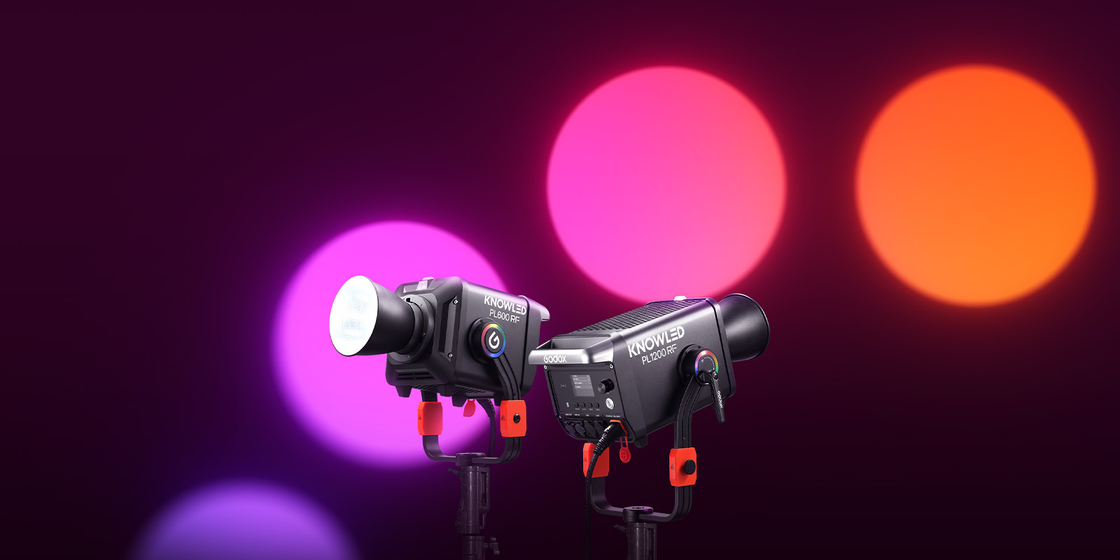 Two Godox lights against a red background