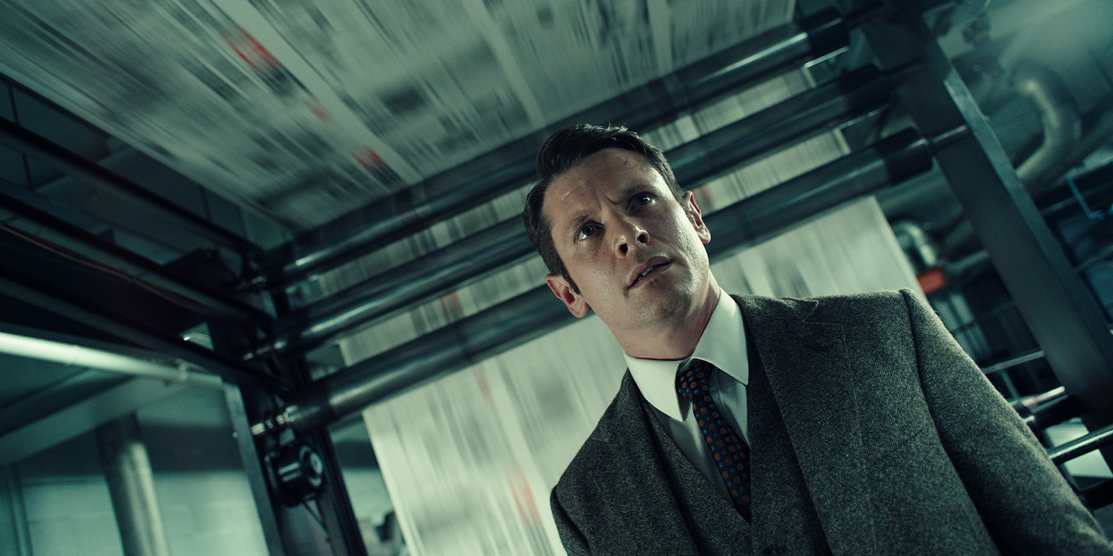 Jack O'Connell in a grey suit