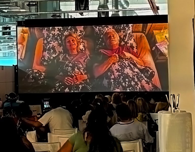 People watching a film on a projector