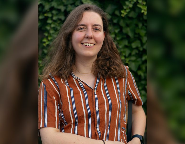 A woman in a stripy shirt smiling