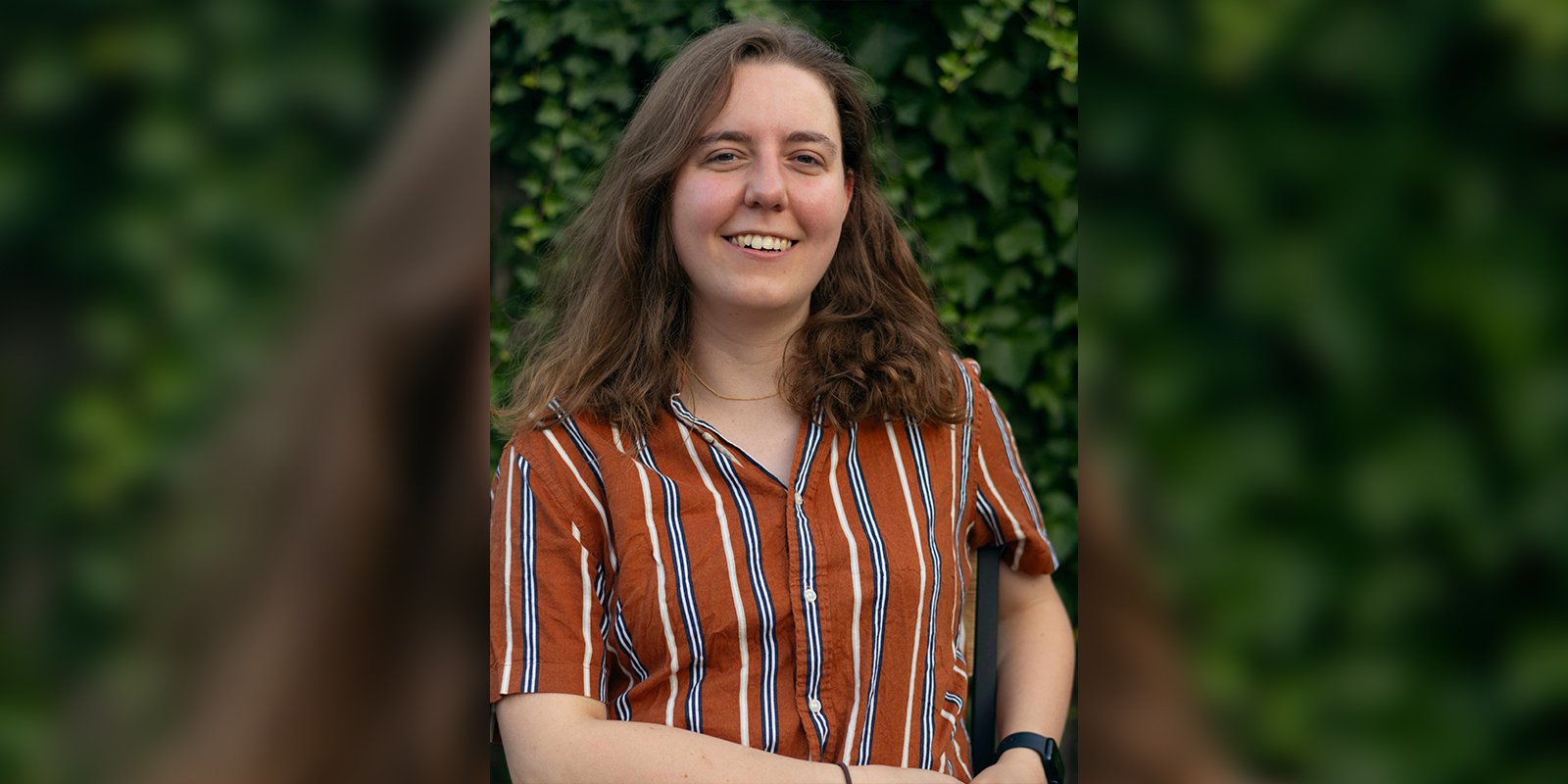 A woman in a stripy shirt smiling